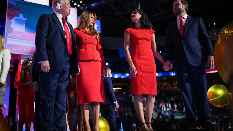 Donald Trump and Melania Trump standing next to Usha Vance and JD Vance, both ladies in red