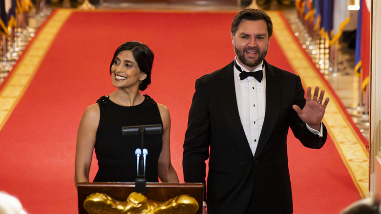 Usha and JD Vance smiling at podium