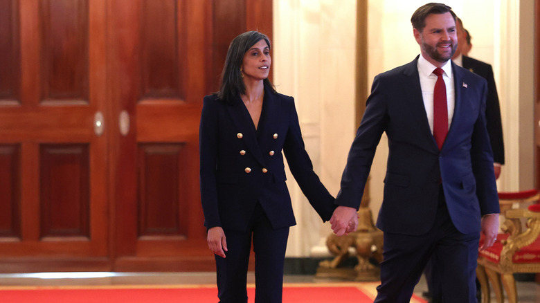 Usha and JD Vance walking while holding hands