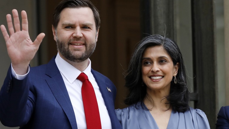 JD Vance smiling and waving, with his wife Usha Vance smiling next to him
