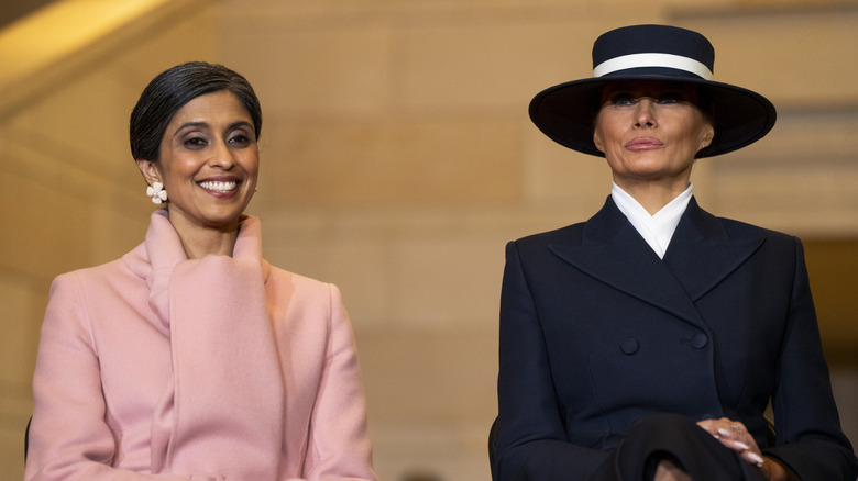 Usha Vance in a pink coat sitting next to Melania Trump in a black coat and hat