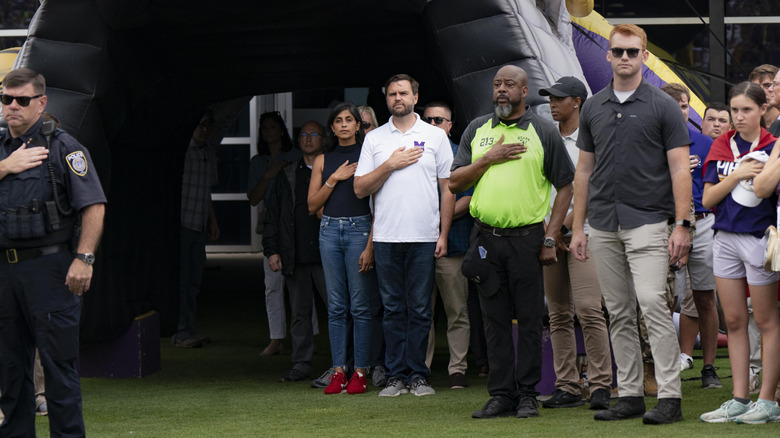 Republican vice presidential nominee, U.S. Sen. J.D. Vance (R-OH) and his wife Usha stand for the national anthem during a campaign stop at a football game between East Carolina University and Appalachian State University on September 14, 2024 in Greenville, North Carolina (2024)
