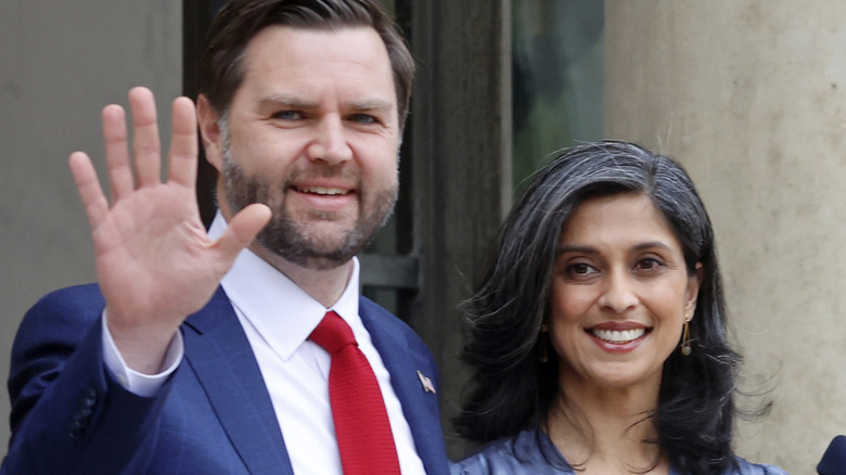 JD Vance waves while standing next to wife Usha Vance