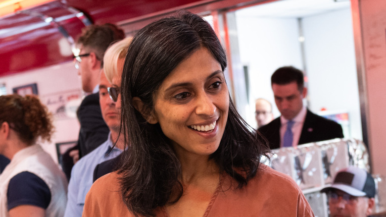 Closeup of Usha Vance smiling in conversation at a diner