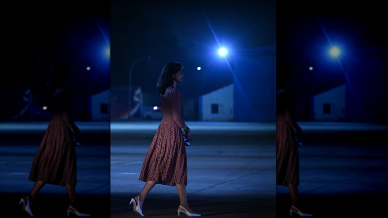 Usha Vance walking across airport tarmac in India at night