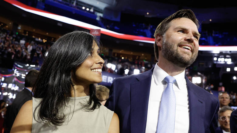 Usha Vance smiling while looking sideways at her husband JD Vance