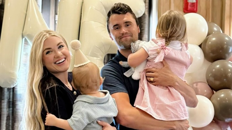 Erika and Charlie Kirk smiling with their kids