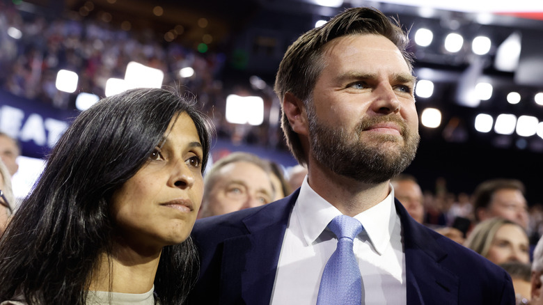 Usha Vance wearing a beige shirt while standing next to JD Vance, who's wearing a suit, at the RNC.