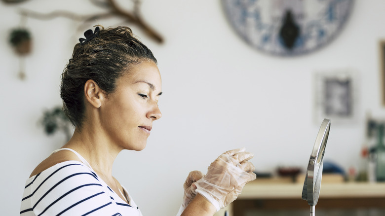 Woman coloring hair at home