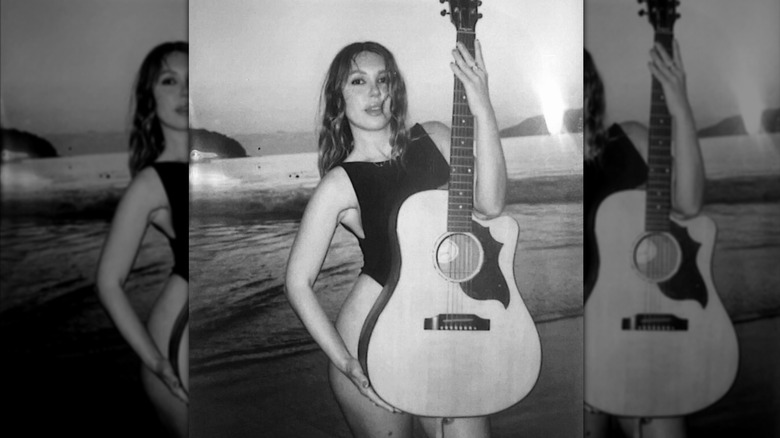 Mercedes Kilmer poses with her guitar on the beach in a photo she posted to Instagram on July 14, 2025.