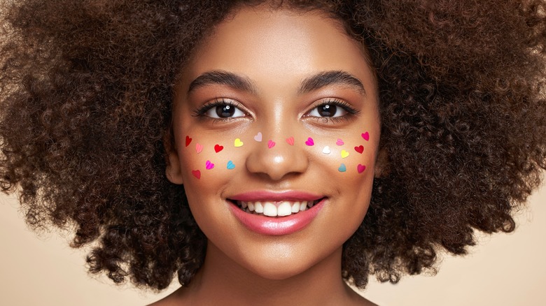 Woman with heart makeup smiling