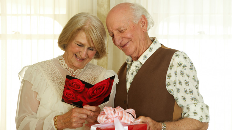 Elderly couple reads a romantic greeting card