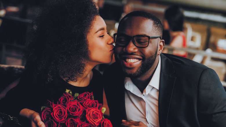 Woman kissing man