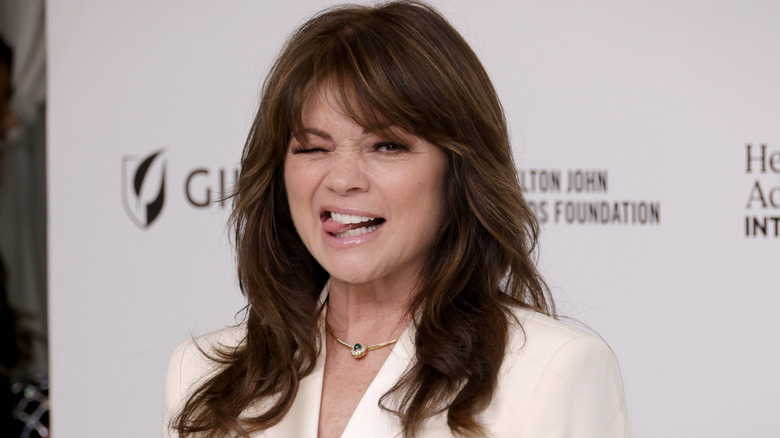 Valerie Bertinelli pulling a silly face on the red carpet in a white blazer