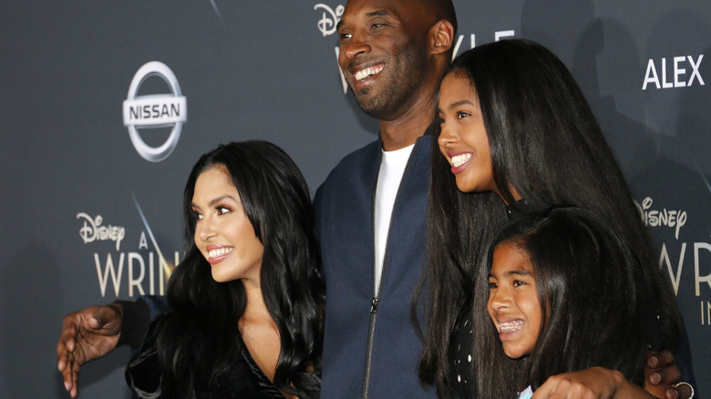 Vanessa Bryant and Kobe Bryant posing on the red carpet with their daughters Natalia and Gianna
