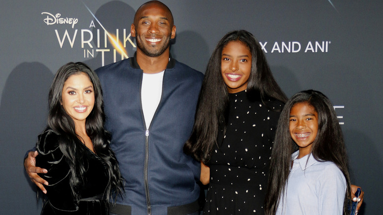 Vanessa Bryant and Kobe Bryant smiling with their daughters Natalia and Gianna