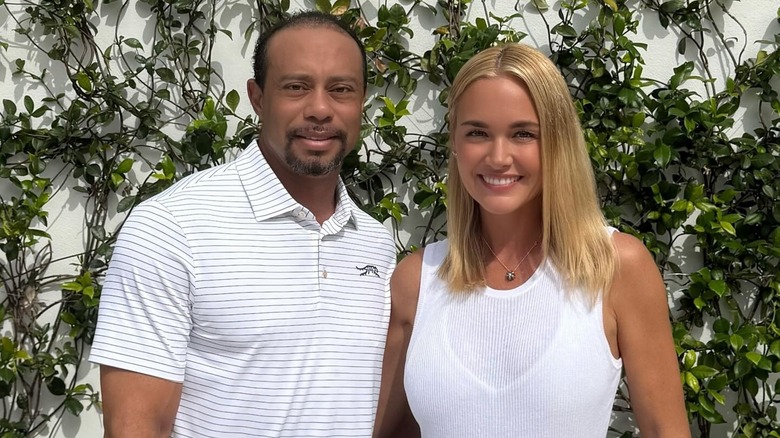 Tiger Woods and Vanessa Trump, both wearing white