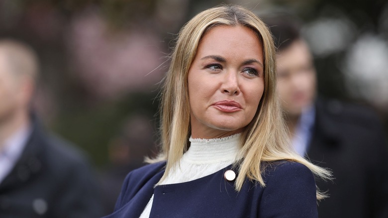 Vanessa Trump in a blue coat looking over her shoulder