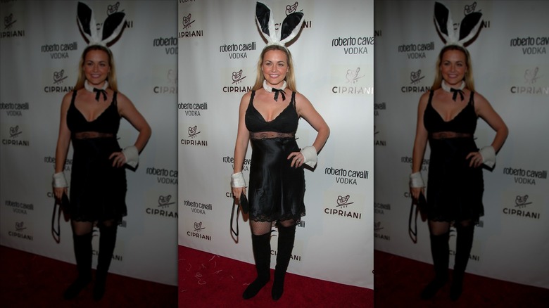 Vanessa Trump posing on step-and-repeat in Playboy bunny constume