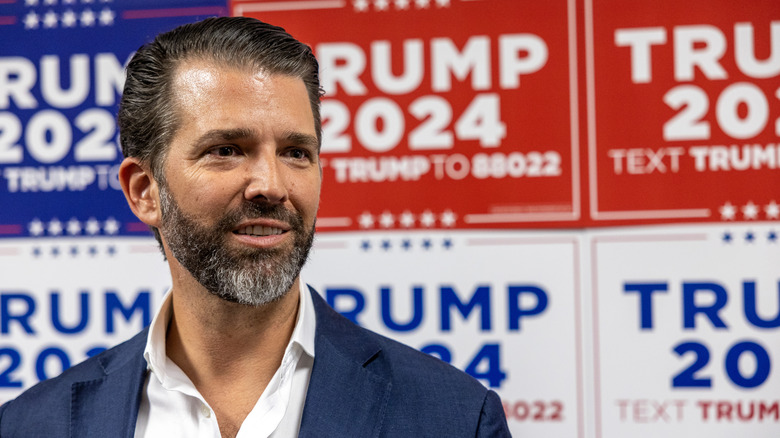 Donald Trump Jr. with campaign signs