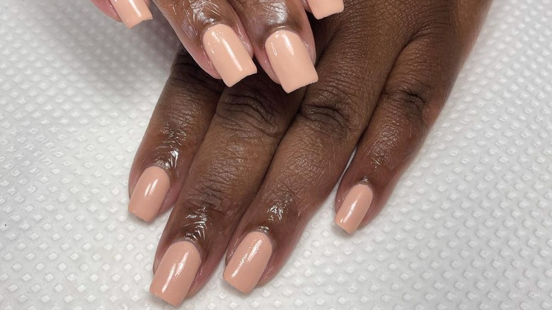 Clean vanilla latte nails on white background