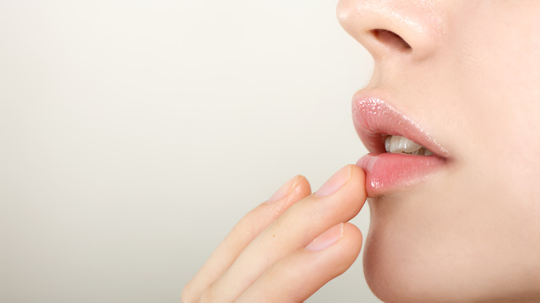A person touching their lips 