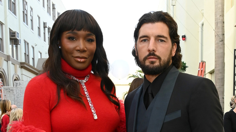 Venus Williams red gown Andrea Preti black suit