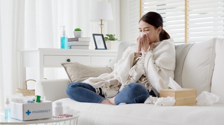 woman sick on couch