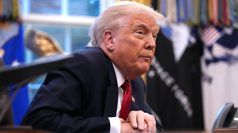 Donald Trump sitting at desk