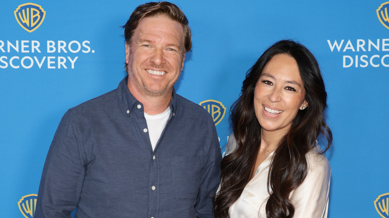 Chip Gaines and Joanna Gaines smiling while posing together at an event