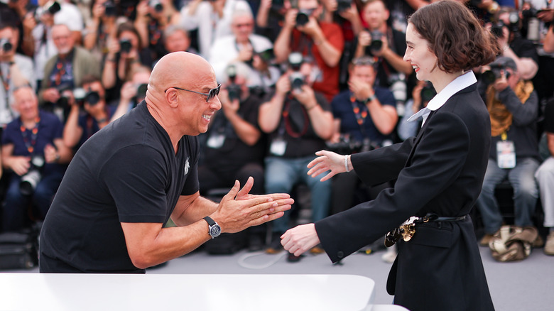 Meadow Walker and Vin Diesel greeting each other with big smiles in front of photographers