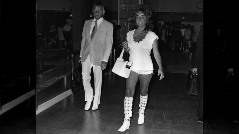 Elizabeth Taylor and Richard Burton walking through London Airport in 1971.