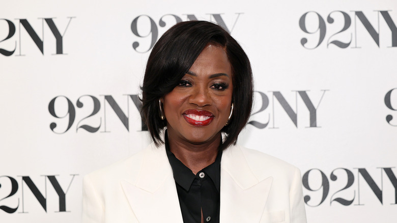 Viola Davis smiling in front of a black and white background