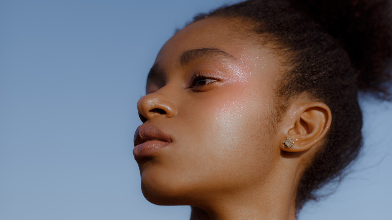 Woman with glitter on face