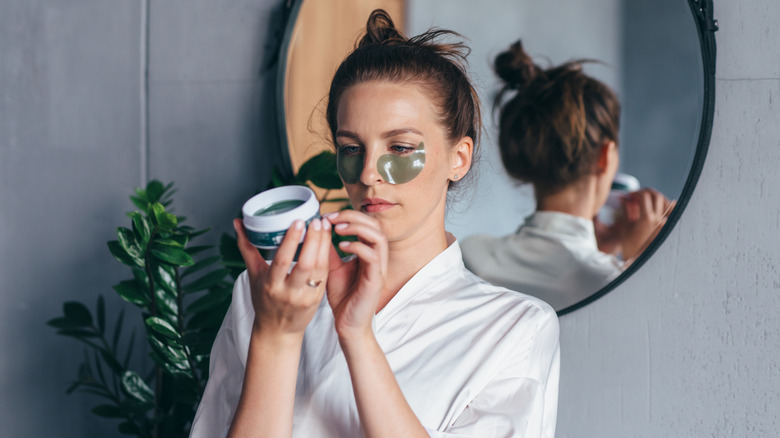 Woman looking at moisturiser