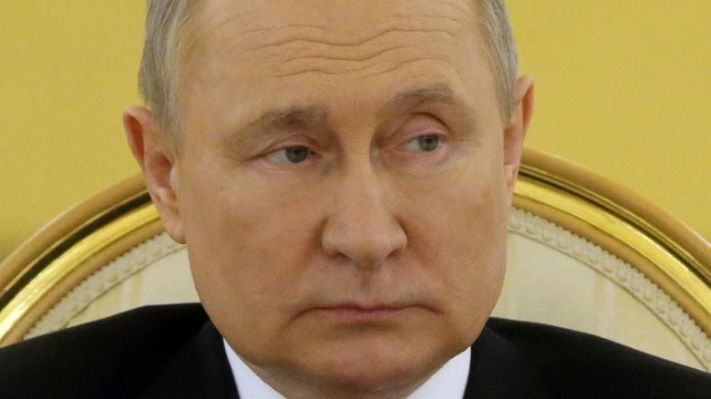 Vladimir Putin looking to his right 