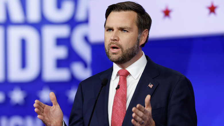 JD Vance speaks at 2024 presidential debate in black suit and red tie
