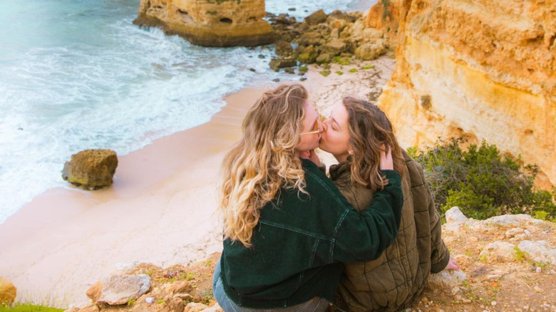 couple kissing on cliff