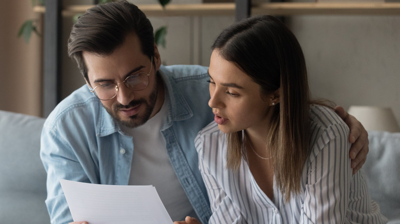 A couple looking at document
