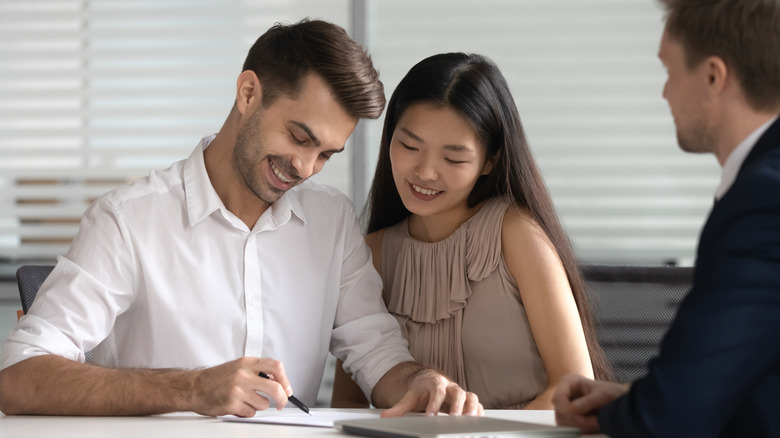 A couple signing a contract