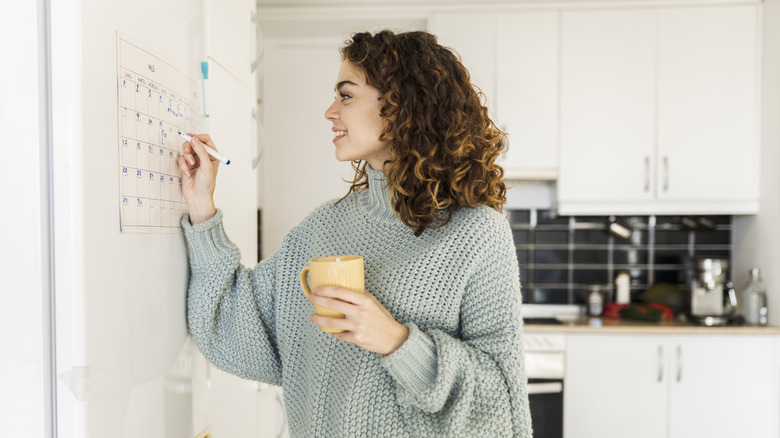 woman marks calendar