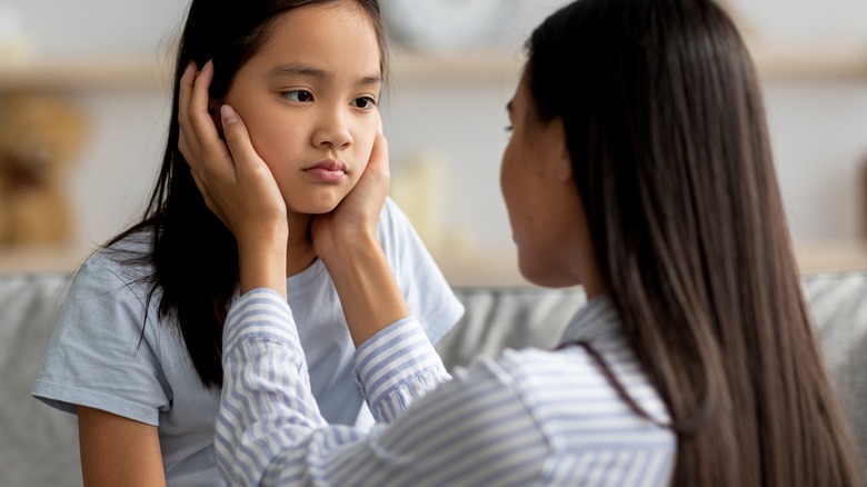 Mother consoling daughter