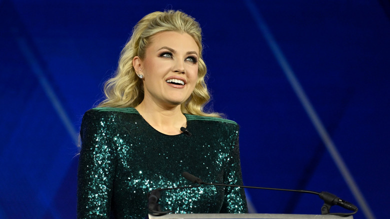Erika Kirk standing at a podium.