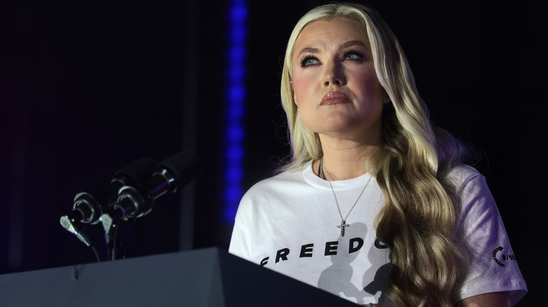 Erika Kirk looking wistful behind a podium