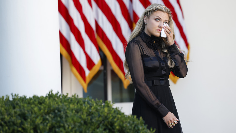 Erika Kirk walking while wiping her eyes