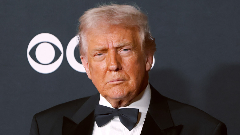 Donald Trump looking grumpy in a black tuxedo