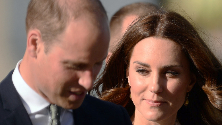 A close-up of Kate Middleton and Prince William talking to one another