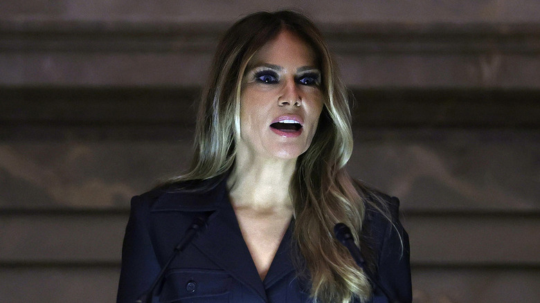 Melania Trump giving a speech, lit from beneath her face 