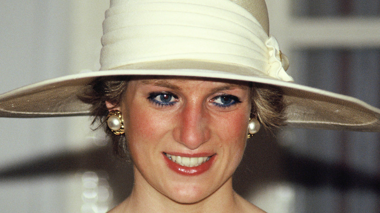 Princess Diana wearing a white hat.  