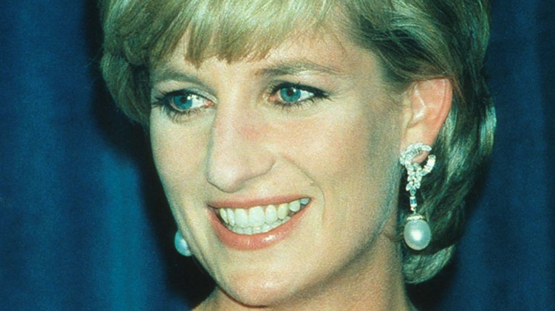 Princess Diana smiling in pearl drop earrings